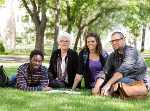 Graduate student seminar with professor on campus lawn