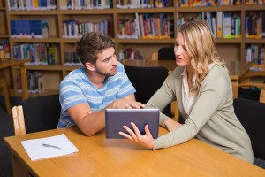 student and tutor studying in the library