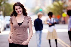 College student smiling on street in New York with her friends