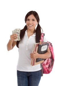 Young female college student holding cash from her student loan to pay for college