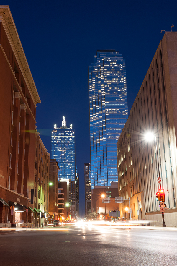 Business tower at nigh from well lit street in Dallas Texas