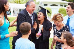 Hispanic family celebrating daughter's college graduation